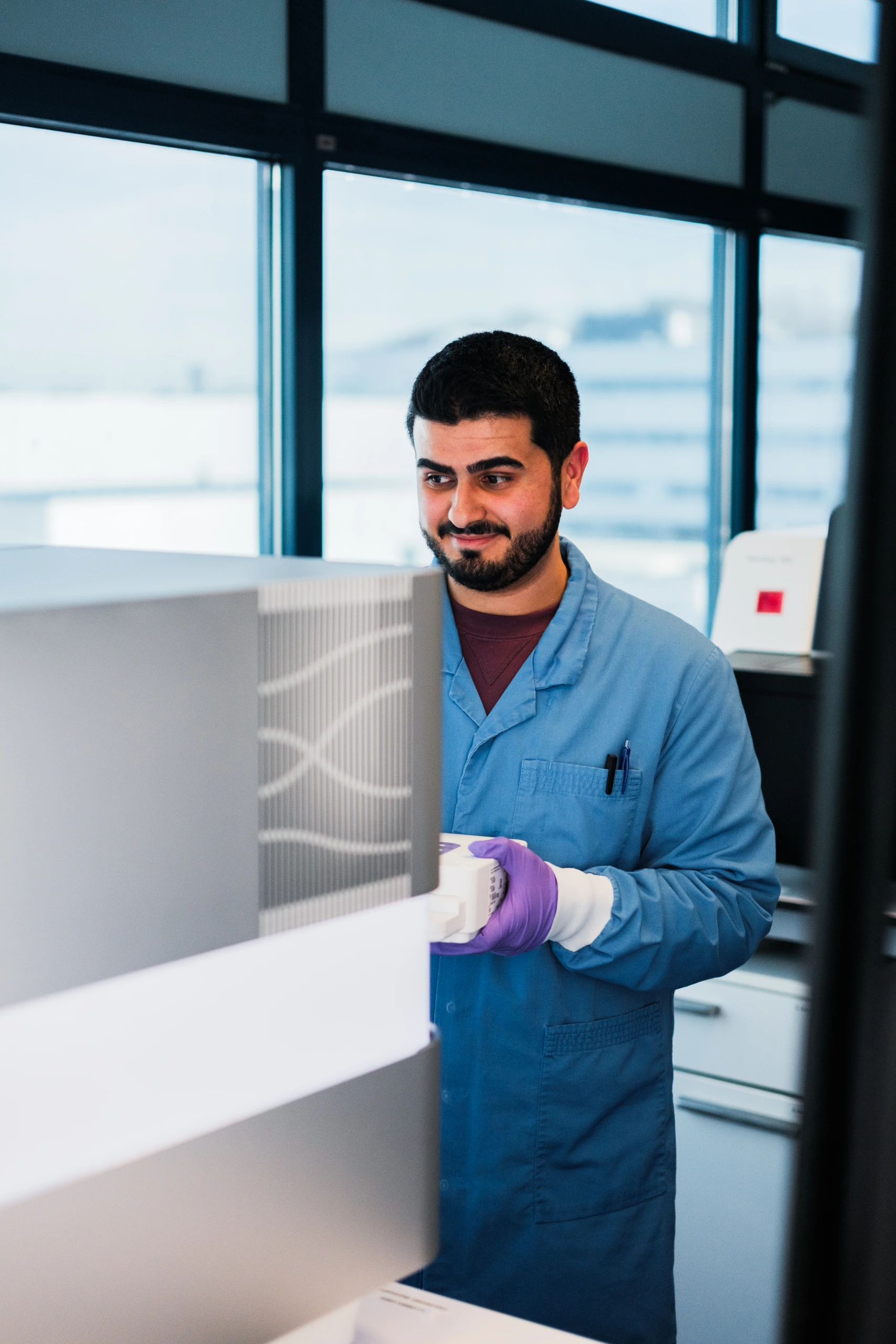 Male scientist operating a touchscreen laboratory analyzer system C