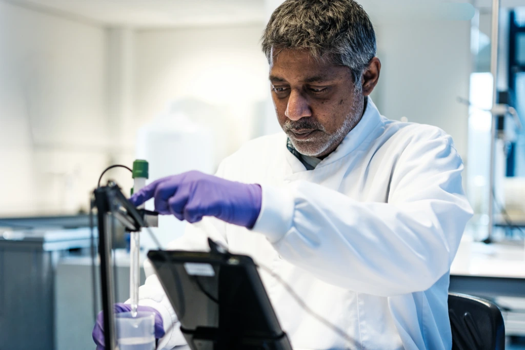 Male scientist testing liquid sample in laboratory A