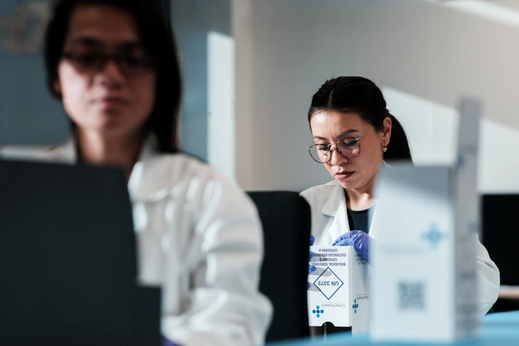Two female scientists sample packing line A