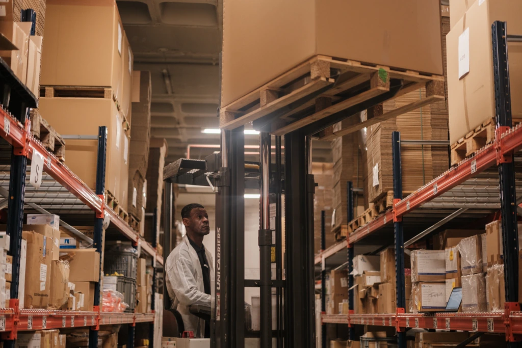 Warehouse worker operating forklift A
