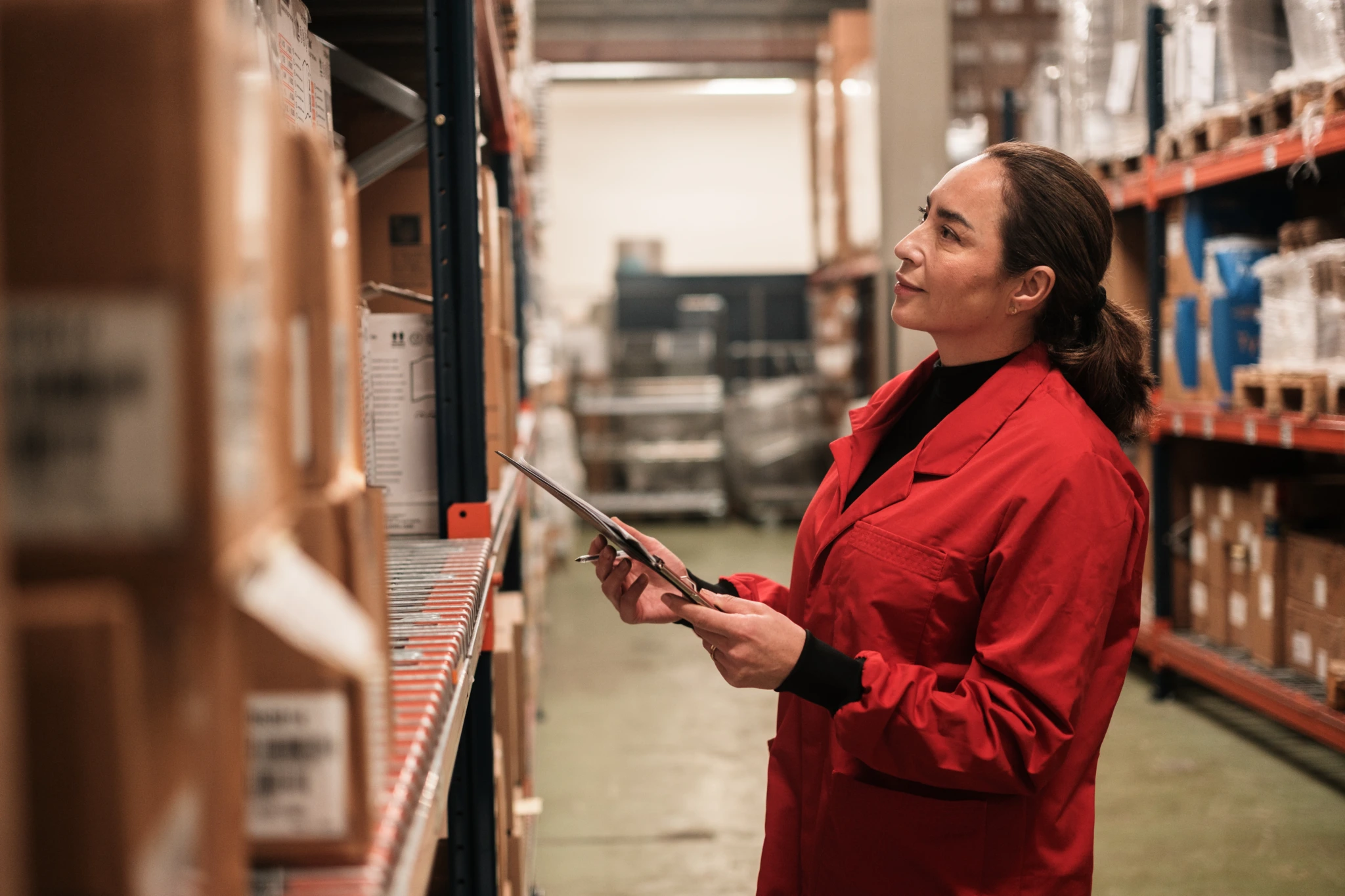 Female warehouse worker checking stock inventory A