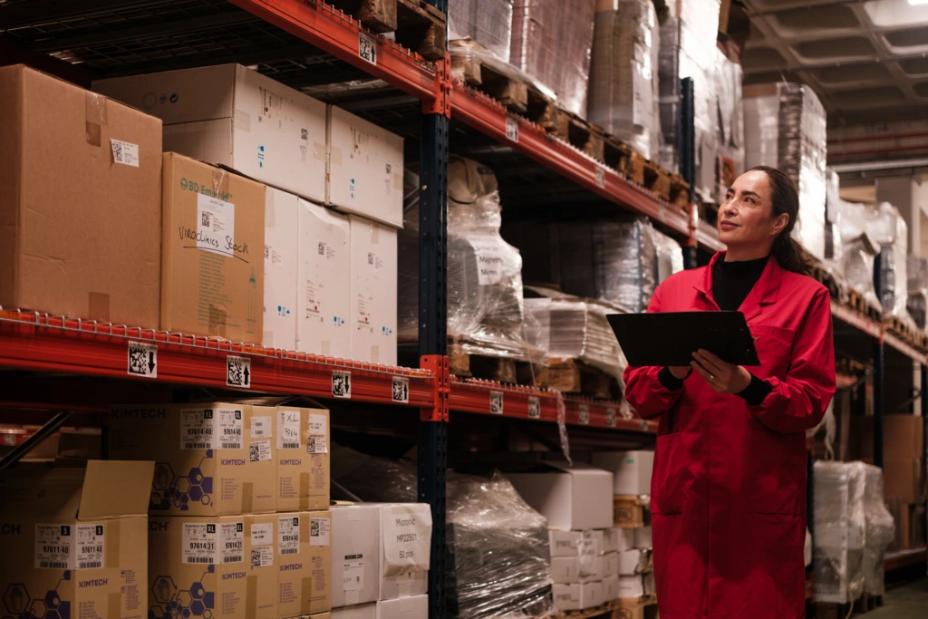 Female warehouse worker checking stock inventory E