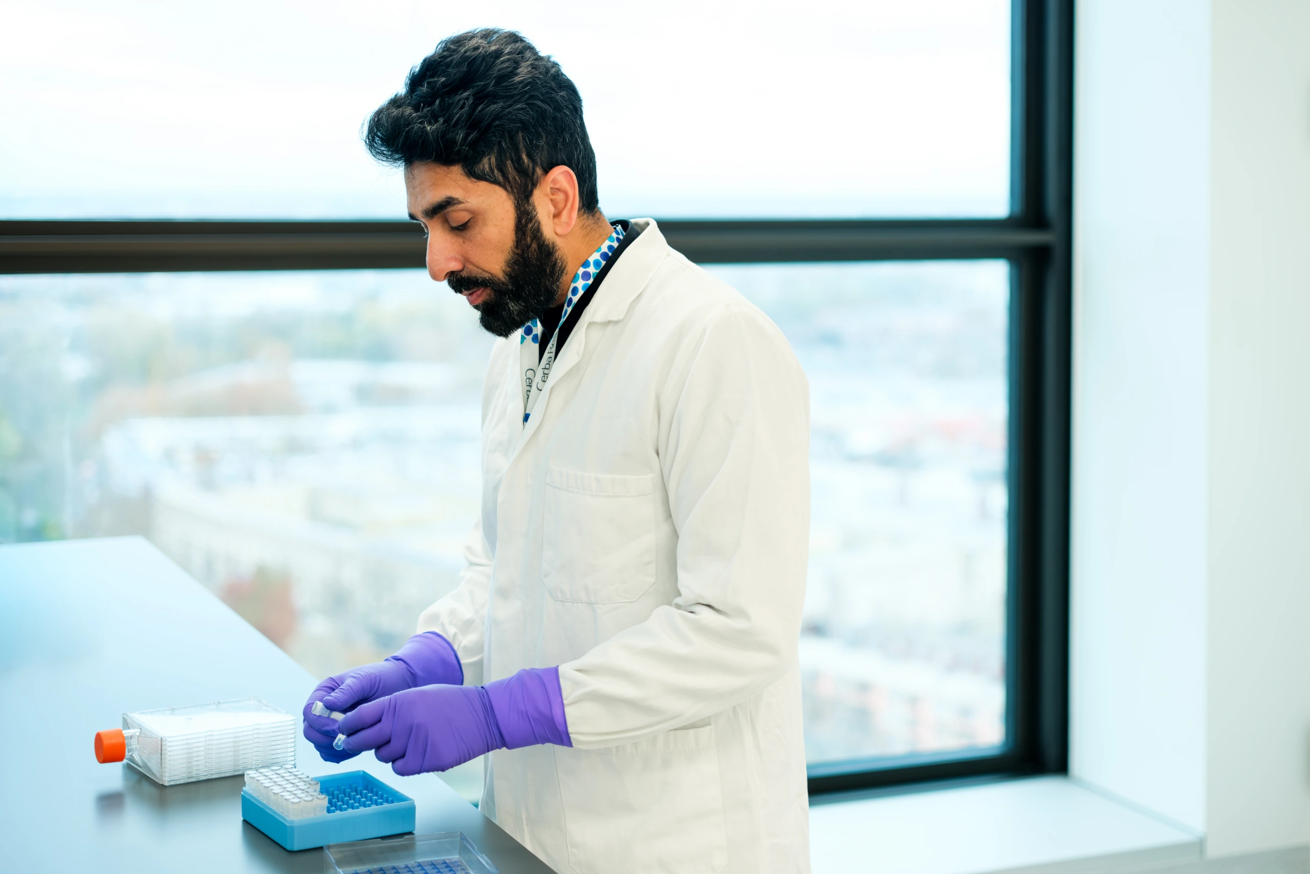 Male scientist preparing laboratory samples beside window