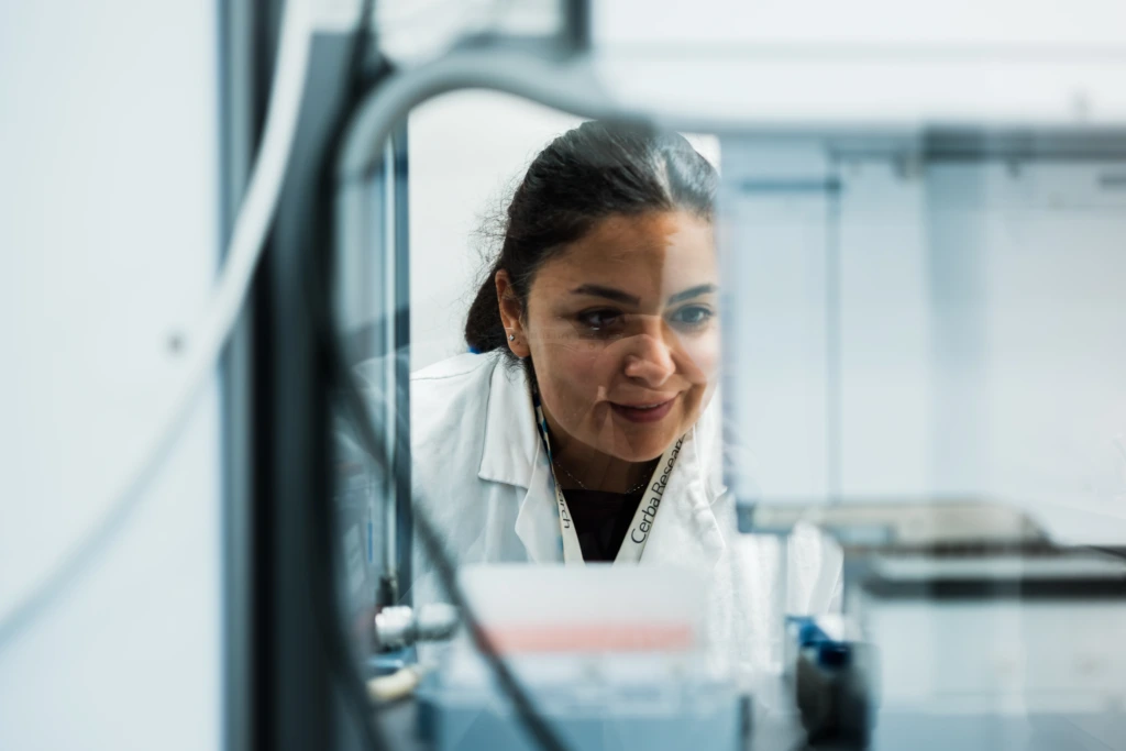 Scientist working through laboratory instrumentation frame