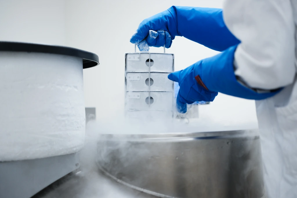 Scientist handling cryogenic laboratory sample storage