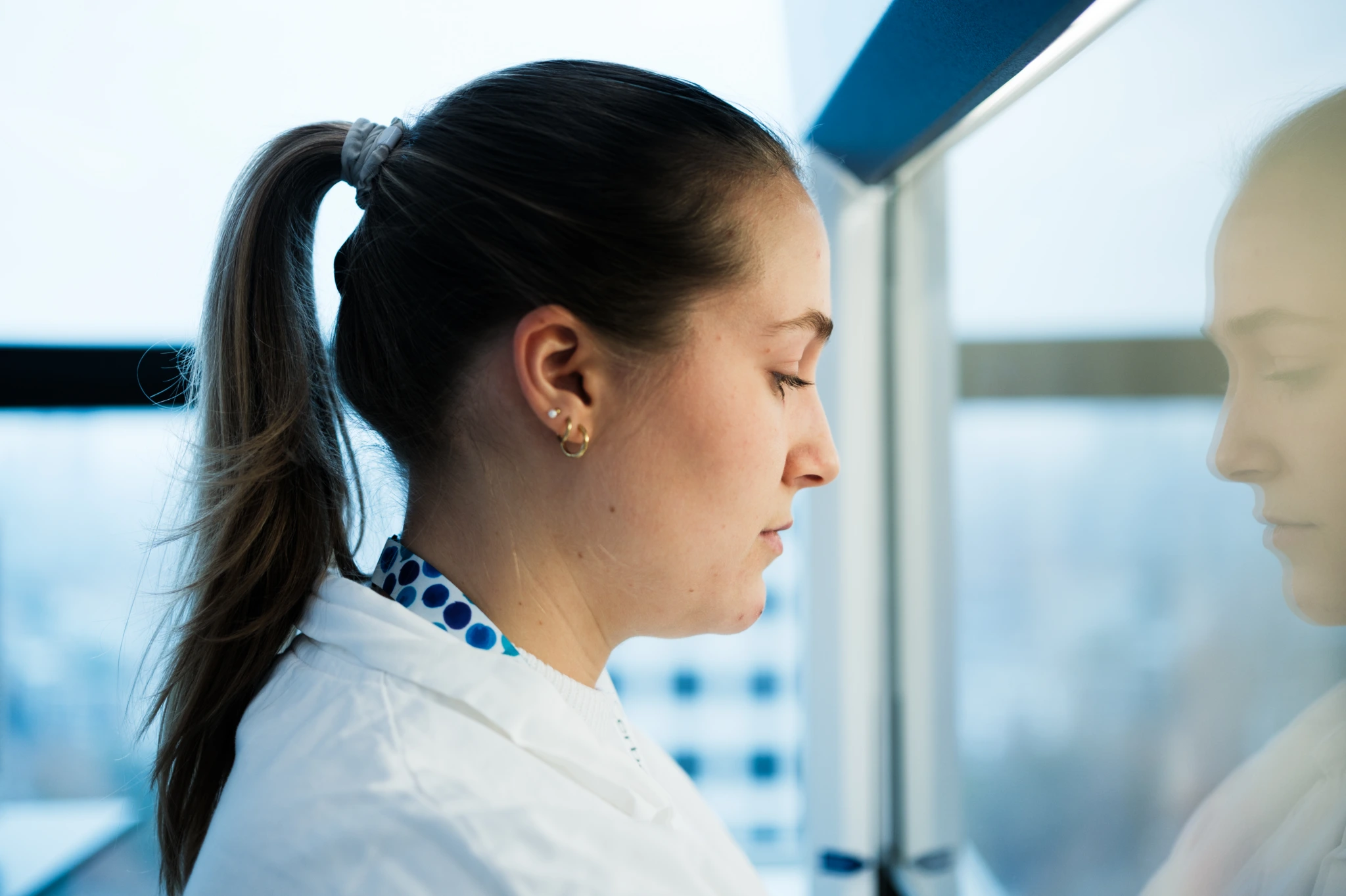 Side profile portrait of female scientist in laboratory
