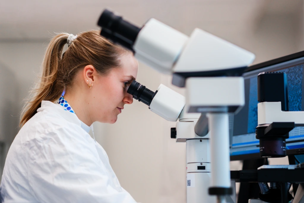 Scientist performing microscopy analysis in laboratory