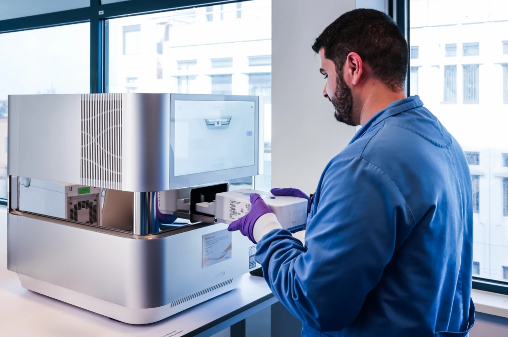 Medium shot of male scientist in blue coat at laboratory instrument