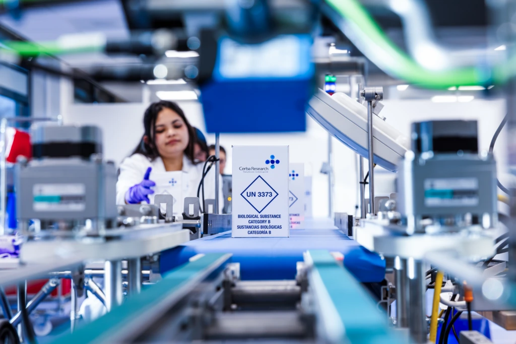 Medium shot of female scientist smiling at bright laboratory bench