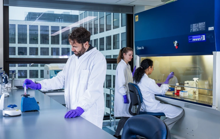 Medium shot of two scientists working at a microscopy station