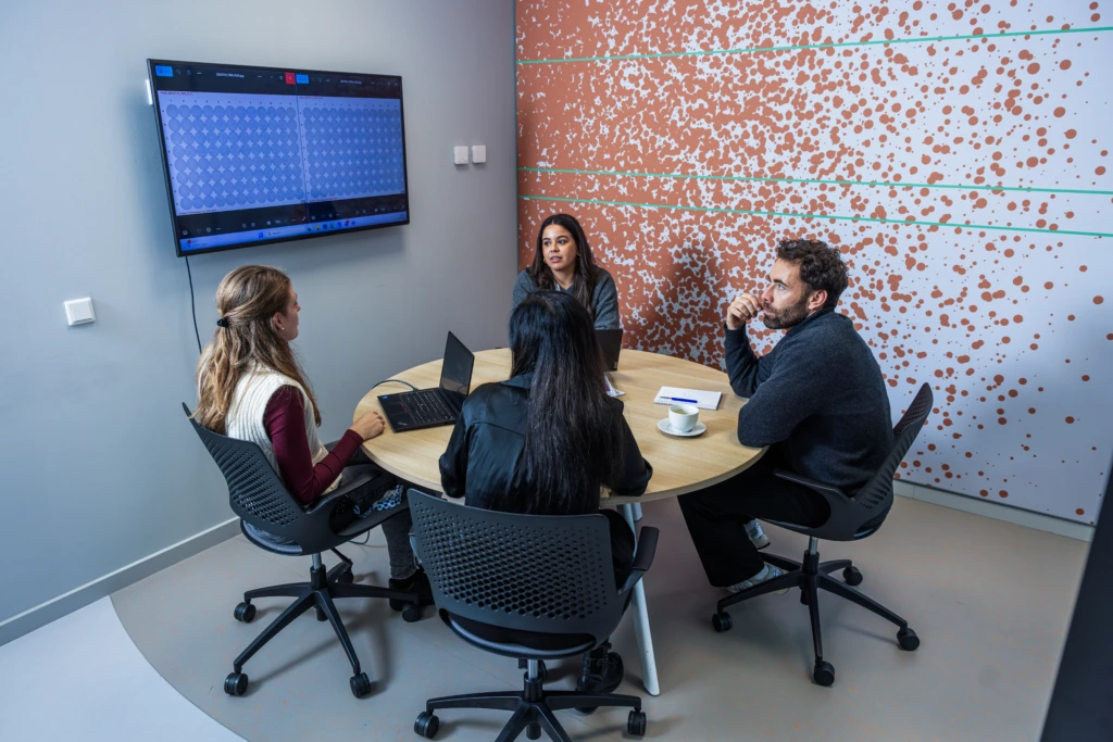 Medium shot of team in CerbaResearch meeting room