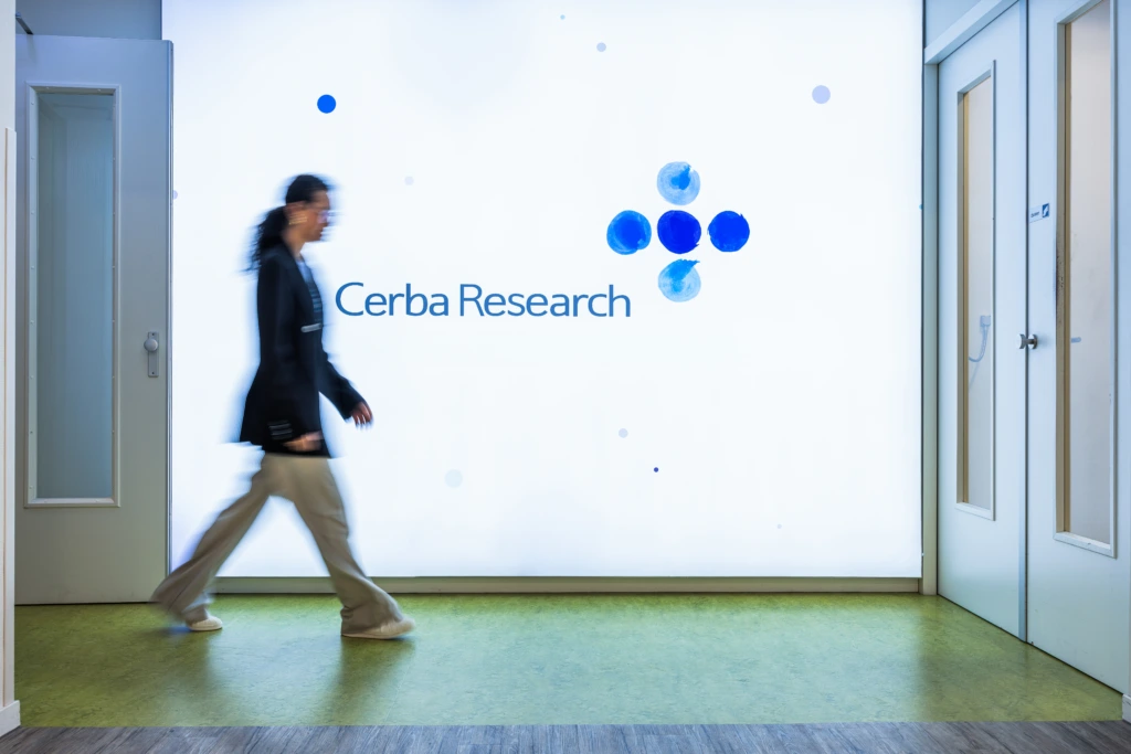 Medium shot of female walking through CerbaResearch branded corridor