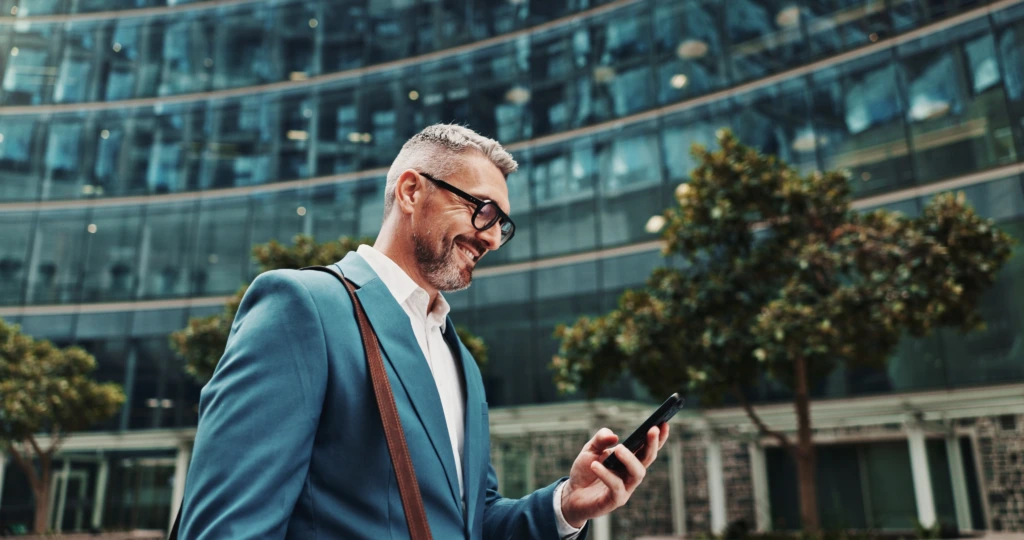 Business,,Smile,And,Man,With,Smartphone,,Outdoor,And,Internet,With